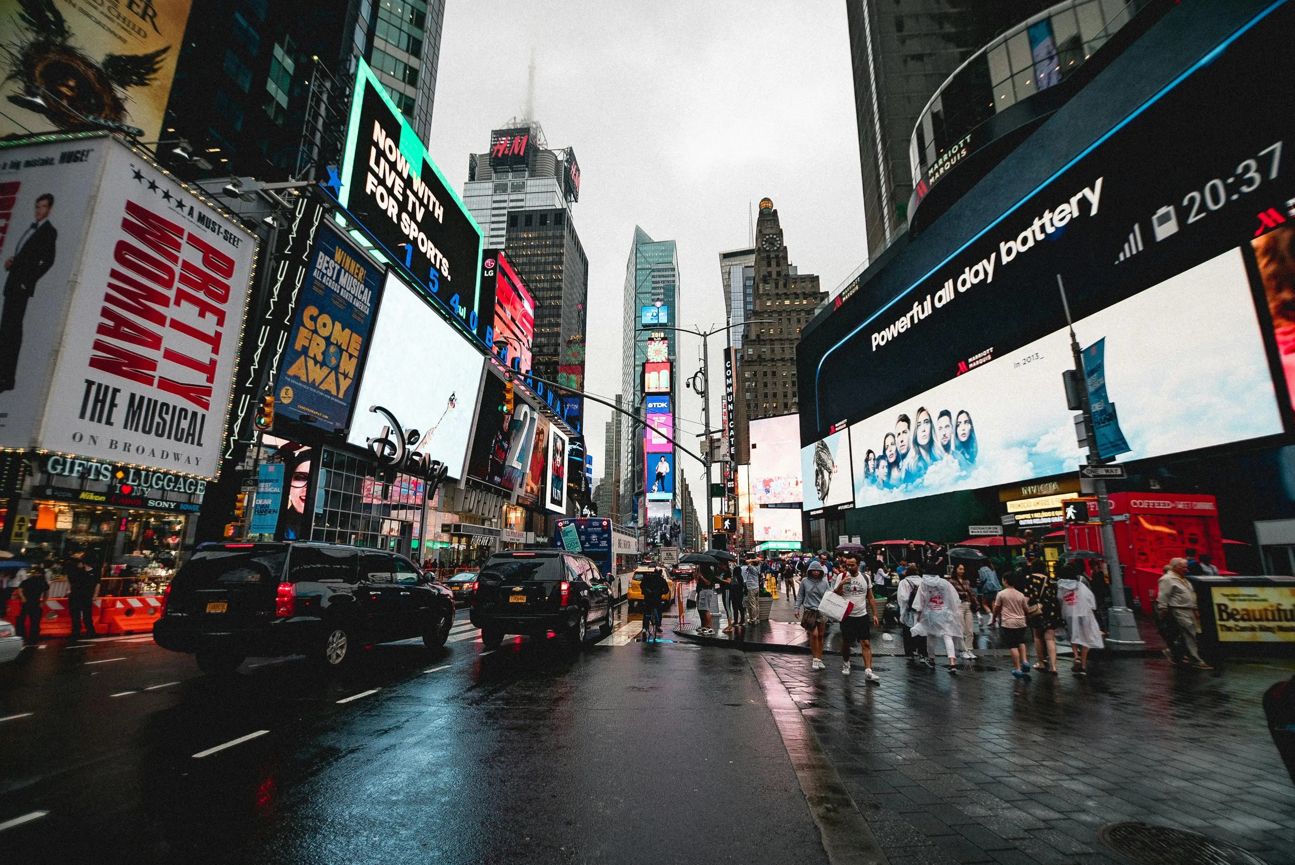 A vibrant view of Times Square at night with neon lights and bustling crowds in New York City.