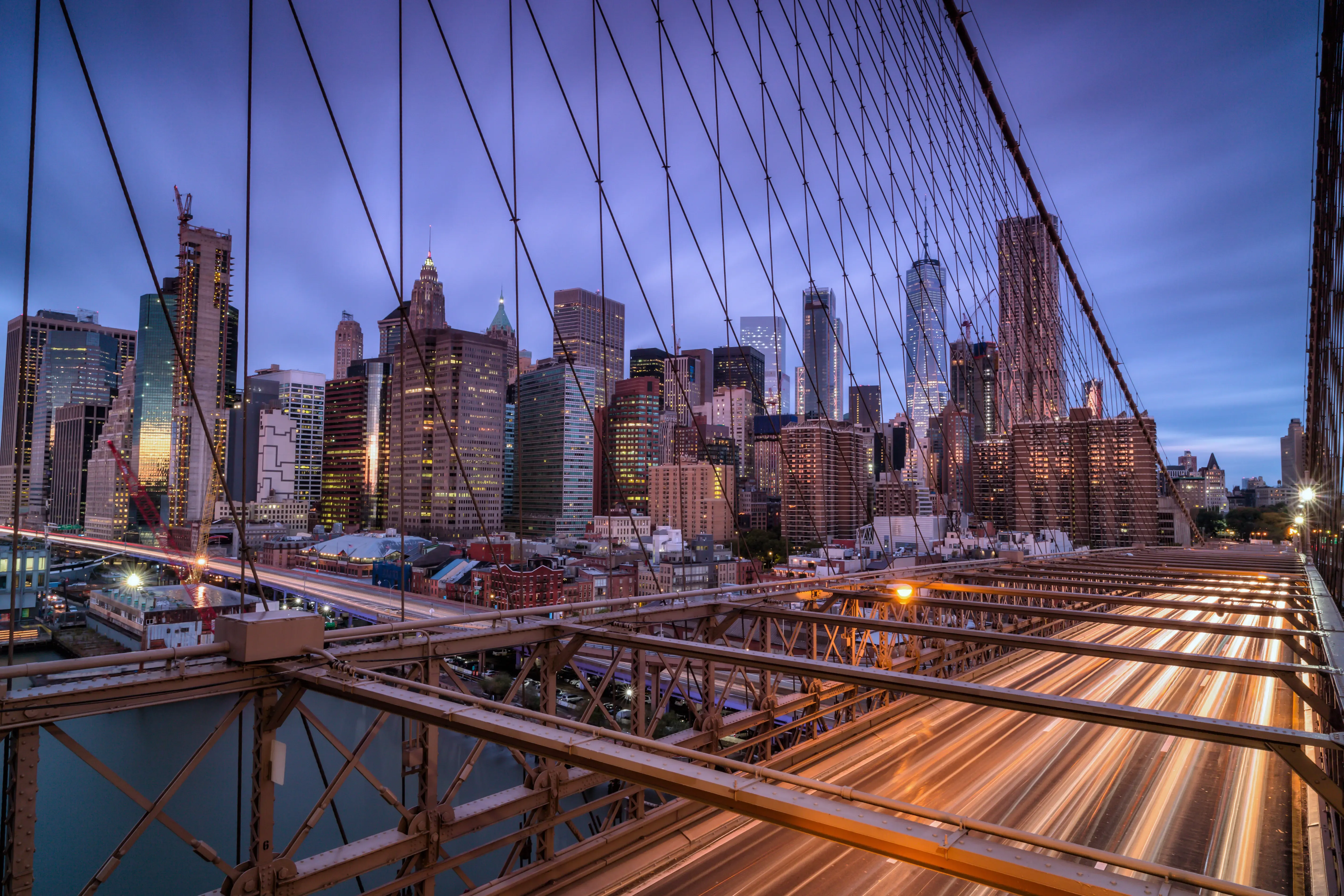 View of the Brooklyn Bridge driveway leading to Downtown Manhattan with skyscrapers in the background.